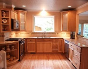 A remodeled kitchen featuring traditional cabinetry and wood flooring.
