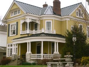 A large Victorian home with a standing seam metal roof.