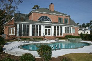 large luxury home with swimming pool and screened in porch